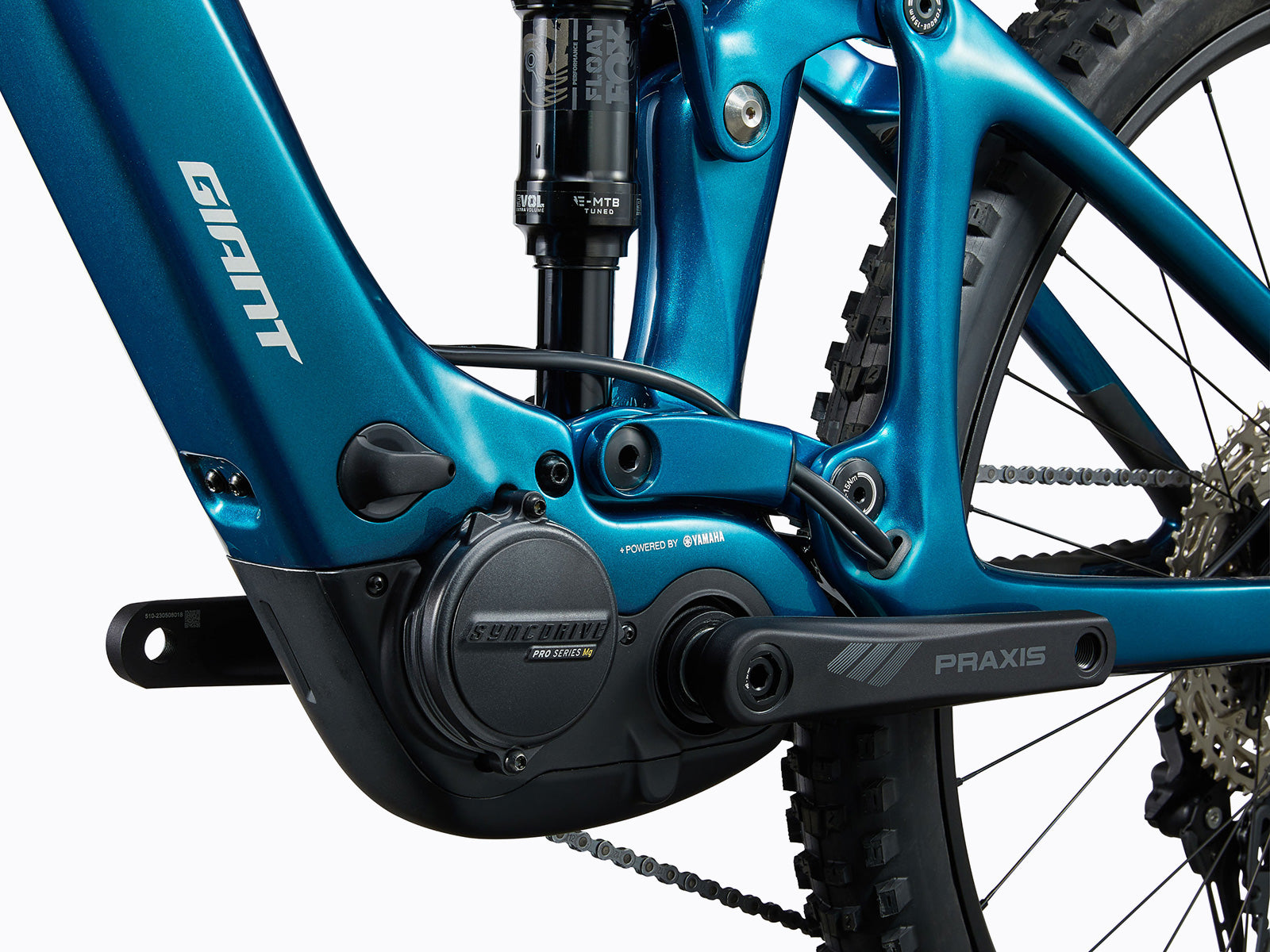 Detailed close-up of a blue bicycle's rear suspension system, highlighting its mechanics and functionality for improved ride comfort.