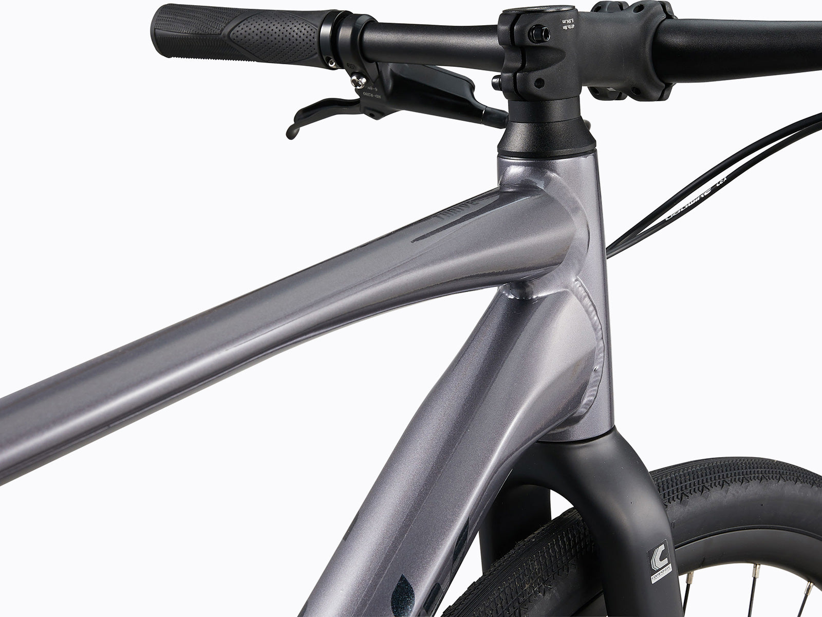 Close-up view of a mountain bike handlebar, showcasing grips, brake levers, and gear shifters.