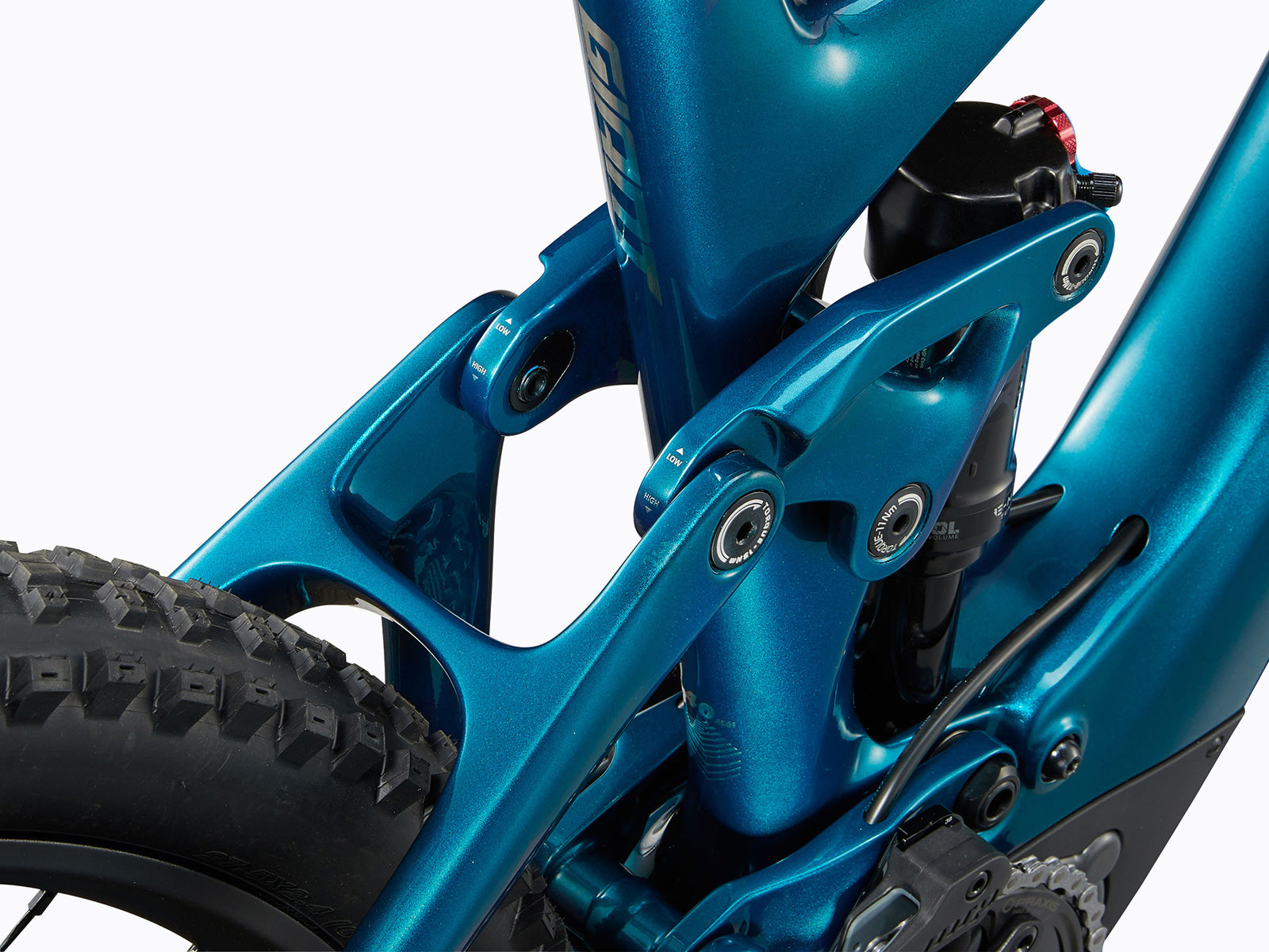 Detailed close-up of a blue bicycle's rear suspension system, highlighting its mechanics and functionality for improved ride comfort.